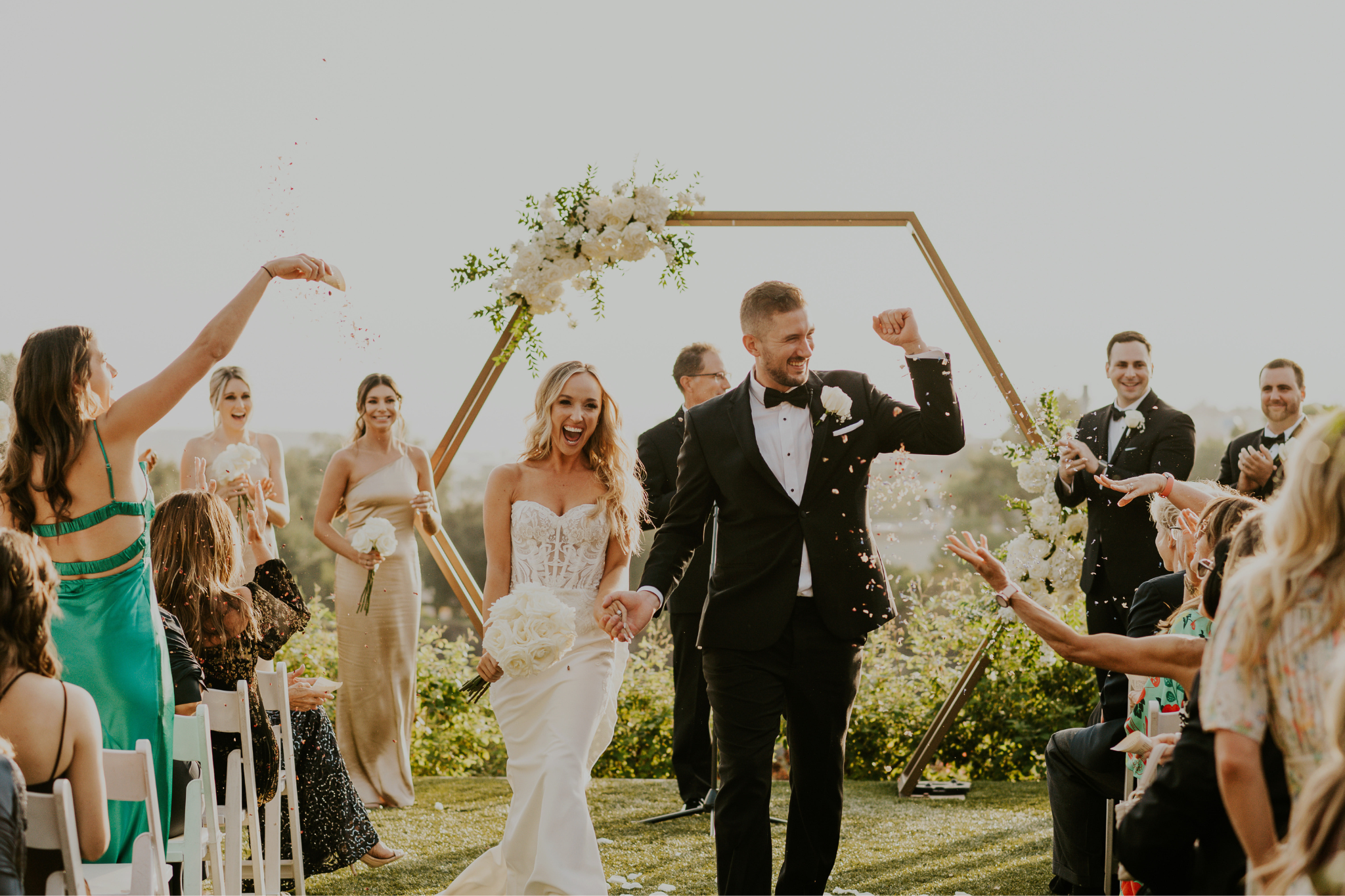 Husband and wide walking down isle after ceremony